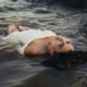 Woman laying in water feeling refreshed