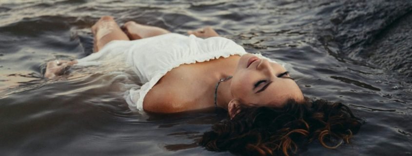 Woman laying in water feeling refreshed