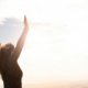 Woman enjoying life with hands raised in the air